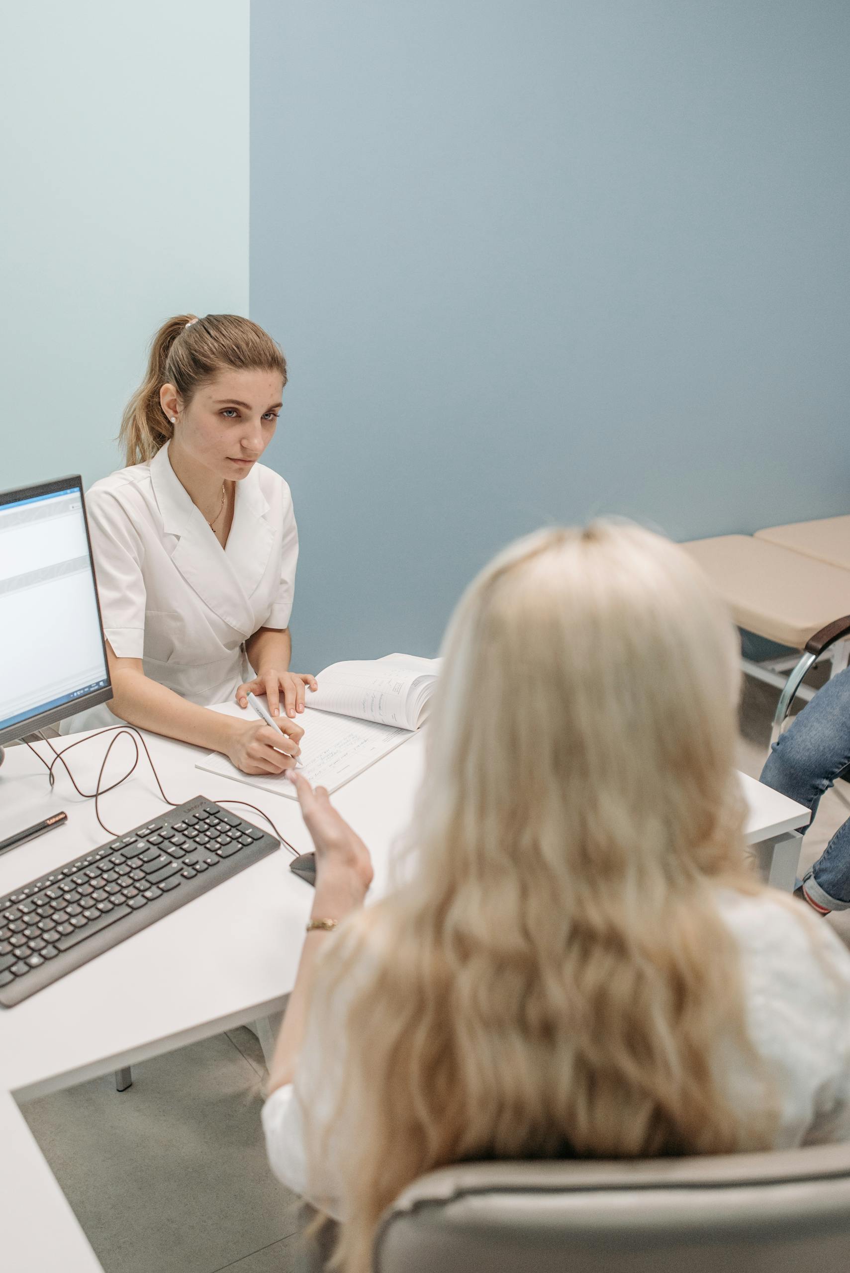 PGD and IVF 4 A doctor consults with a patient in a modern office setting, fostering communication.